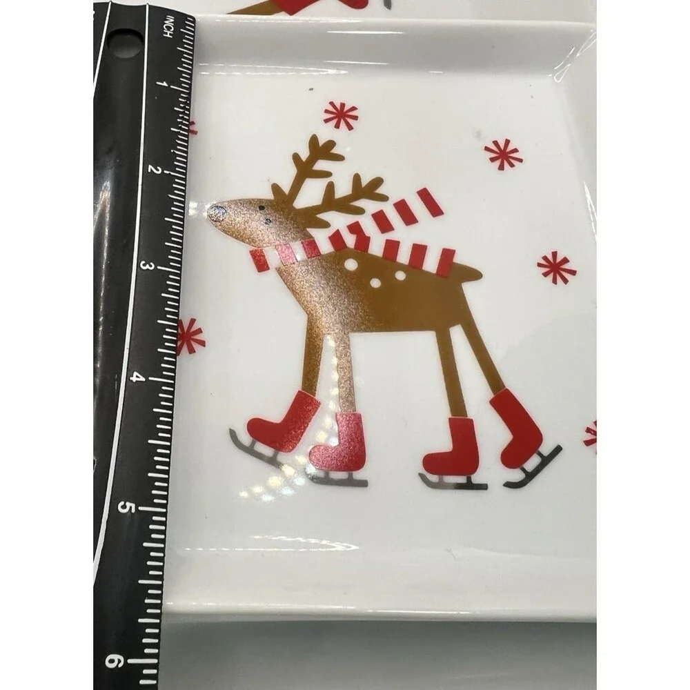 CRATE & BARREL SKATING REINDEER CHRISTMAS 4 plates christmas